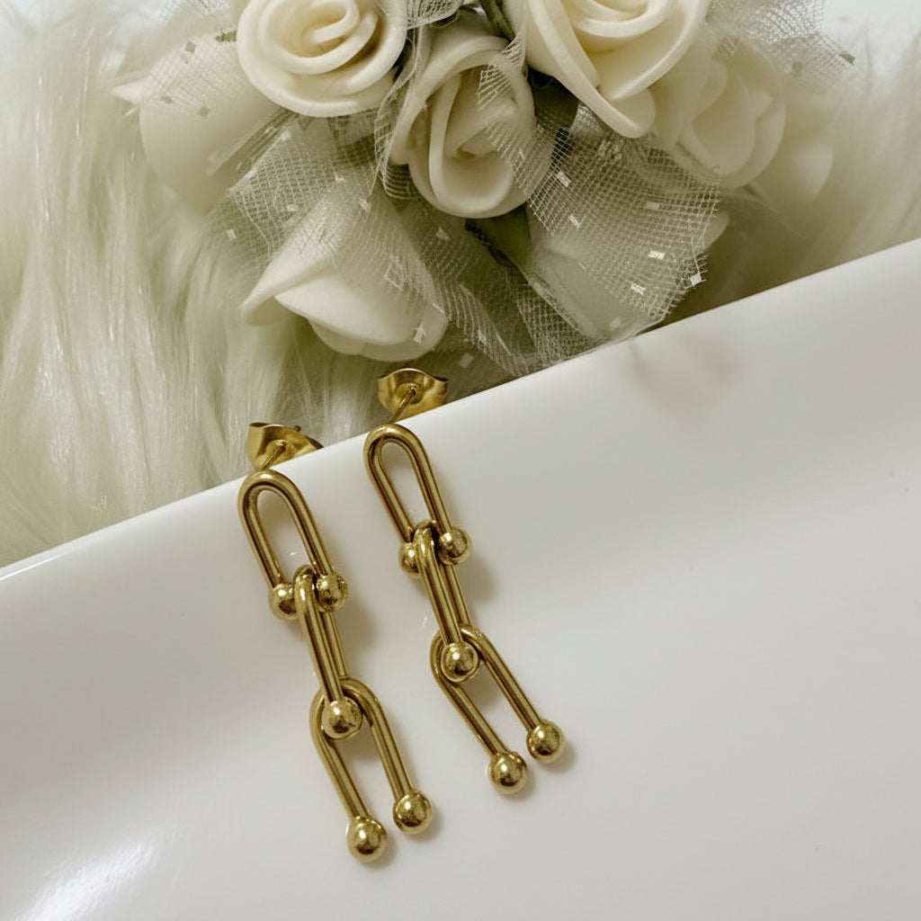 A pair of gold-toned drop earrings with a chain-link design 